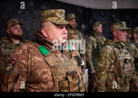 Kharkiv, Ukraine. 22nd Mar, 2023. Ukrainian soldiers listen as President Volodymyr Zelenskyy delivers remarks during a visit to frontline positions in the Kharkiv region, March 22, 2023 in Kharkiv, Kharkiv Oblast, Ukraine. Credit: Pool Photo/Ukrainian Presidential Press Office/Alamy Live News Stock Photo