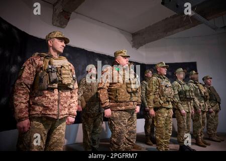 Kharkiv, Ukraine. 22nd Mar, 2023. Ukrainian soldiers listen as President Volodymyr Zelenskyy delivers remarks during a visit to frontline positions in the Kharkiv region, March 22, 2023 in Kharkiv, Kharkiv Oblast, Ukraine. Credit: Pool Photo/Ukrainian Presidential Press Office/Alamy Live News Stock Photo