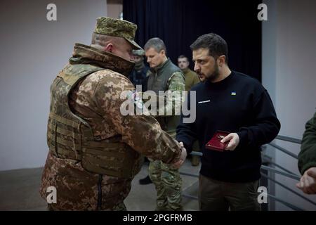 Kharkiv, Ukraine. 22nd Mar, 2023. Ukrainian President Volodymyr Zelenskyy, right, awards a state medal to a soldier during a visit to frontline positions in the Kharkiv region, March 22, 2023 in Kharkiv, Kharkiv Oblast, Ukraine. Credit: Pool Photo/Ukrainian Presidential Press Office/Alamy Live News Stock Photo