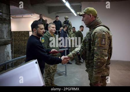 Kharkiv, Ukraine. 22nd Mar, 2023. Ukrainian President Volodymyr Zelenskyy, left, awards a state medal to a soldier during a visit to frontline positions in the Kharkiv region, March 22, 2023 in Kharkiv, Kharkiv Oblast, Ukraine. Credit: Pool Photo/Ukrainian Presidential Press Office/Alamy Live News Stock Photo