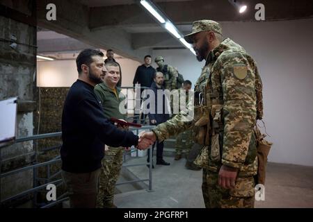 Kharkiv, Ukraine. 22nd Mar, 2023. Ukrainian President Volodymyr Zelenskyy, left, awards a state medal to a soldier during a visit to frontline positions in the Kharkiv region, March 22, 2023 in Kharkiv, Kharkiv Oblast, Ukraine. Credit: Pool Photo/Ukrainian Presidential Press Office/Alamy Live News Stock Photo