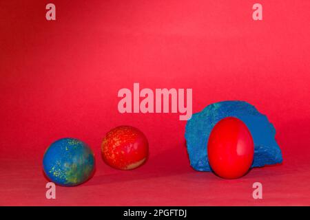 red egg on the blue stone, creative holiday design, happy Easter Stock Photo