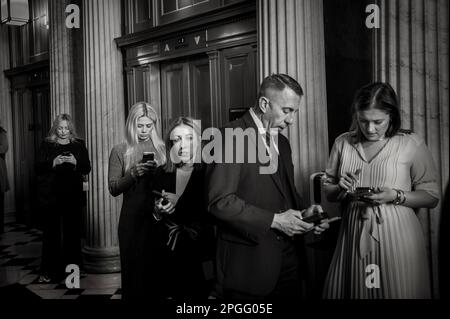 Washington, Vereinigte Staaten. 22nd Mar, 2023. Staffers, reporters and caterers do their work outside of the Senate Republicanâs policy luncheon at the US Capitol in Washington, DC, Wednesday, March 22, 2023. Credit: Rod Lamkey/CNP/dpa/Alamy Live News Stock Photo