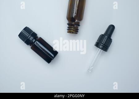 Helsinki / Finland - MARCH 23, 2023, Flatlay closeup of brown glass medical containers and a pipette. Stock Photo