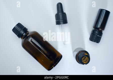 Helsinki / Finland - MARCH 23, 2023, Flatlay closeup of brown glass medical containers and a pipette. Stock Photo