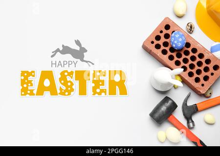 Greeting card for Happy Easter with brick and builder's tools on light background Stock Photo