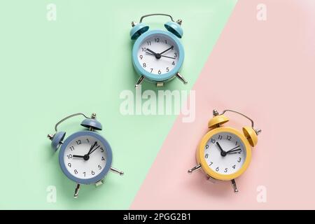 Three alarm clocks on color background Stock Photo