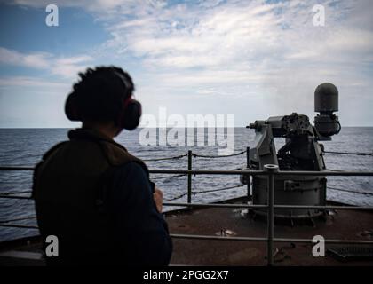 230322-N-XK462-1497 PHILIPPINE SEA (March 22, 2023) A U.S. Navy Sailor fires a 25 mm machine gun during a live-fire exercise aboard the aircraft carrier USS Nimitz (CVN 68). Nimitz is in U.S. 7th Fleet conducting routine operations. 7th Fleet is the U.S. Navy's largest forward-deployed numbered fleet, and routinely interacts and operates with Allies and partners in preserving a free and open Indo-Pacific region. (U.S. Navy photo by Mass Communication Specialist 3rd Class Hannah Kantner) Stock Photo