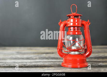 Vintage oil lamp on wooden background with copy space Stock Photo