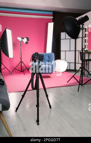 Stylish blue armchair in photo studio with professional equipment Stock Photo
