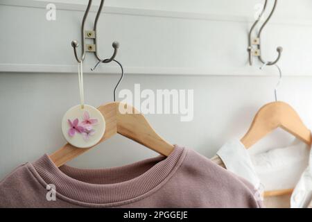 Scented sachet with flowers and stylish clothes on hanger Stock Photo -  Alamy