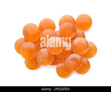 Many orange cough drops on white background, top view Stock Photo