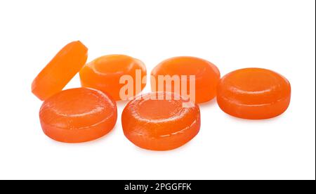 Many orange cough drops on white background Stock Photo