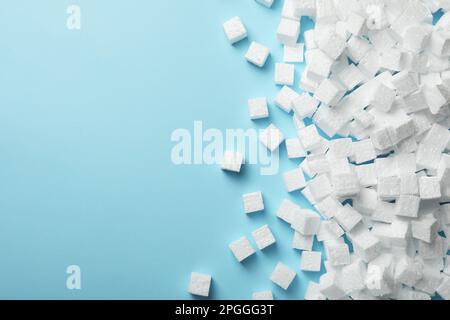 Many styrofoam cubes on light blue background, flat lay. Space for text Stock Photo