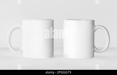 Blank ceramic mugs on white background. Mockup for design Stock Photo