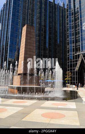 Water fountains rise and splash around an obelisk in PPG Place, an urban city plaza in Pittsburgh, Pennsylvania Stock Photo