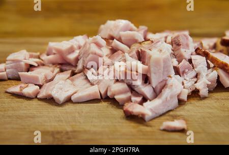 Sliced bacon in the kitchen on cutting board ready for cooking. Stock Photo