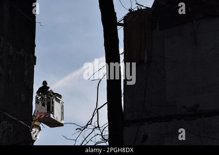 Zaporizhzhia, Ukraine. 22nd Mar, 2023. Firefighters put out a fire after a Russian missile hit a residential multi-story building in Zaporizhzhia. On 22 March at about 12:00, the Russian forces launched 6 missiles on the city of Zaporizhzhia. One of them struck two apartment blocks standing next to each other. At least 33 people were injured and one person died. There were three children among the injured. Credit: SOPA Images Limited/Alamy Live News Stock Photo