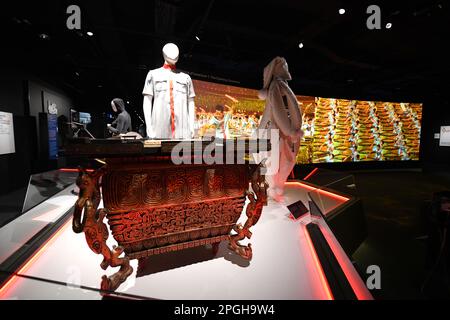Lausanne, Switzerland. 22nd Mar, 2023. An instrument and a costume once used at the opening ceremony of the 2008 Beijing Olympic Games are displayed with the screen displaying the ceremony in the background at the International Olympic Museum in Lausanne, Switzerland, March 22, 2023. Credit: Lian Yi/Xinhua/Alamy Live News Stock Photo