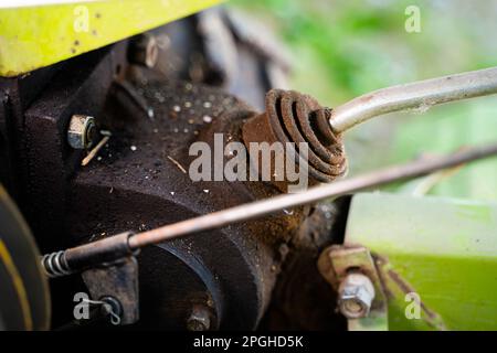 Gear lever on a walk-behind tractor close-up on a blurred background. Control elements of agricultural machinery. Rototiller connection and gear shift Stock Photo