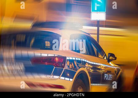Symbol image of police action: Police car in darkness Stock Photo