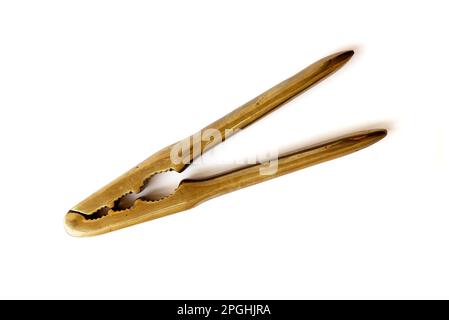Closed antique brass nutcracker on white background Stock Photo
