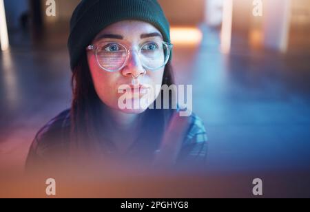 Cybersecurity, phishing and woman hacker working on a computer in the basement at night for malware. Database, password and ransomware with a female Stock Photo