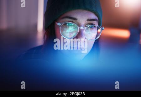 Cybersecurity, database and woman hacker working on a computer in the basement at night for phishing. Malware, password and ransomware with a female Stock Photo