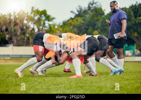 Rugby, scrum or men training with coach on grass field ready for match, practice or sports game. Fitness, performance or strong athletes in tackle for Stock Photo