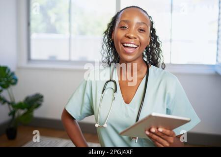 Portrait of a young Black female doctor, laughing with digital tablet Stock Photo