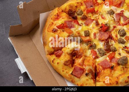 close-up of delicious pizza still in cardboard box Stock Photo