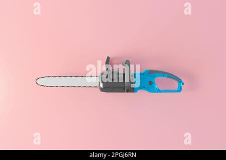 A sharp hand saw with a chain lies isolated on a flat pink background. Top view of a handy hand saw for working in the garden. Creative gardening Stock Photo
