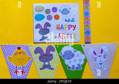 Happy Easter decorations, bunting and stickers on yellow background Stock Photo