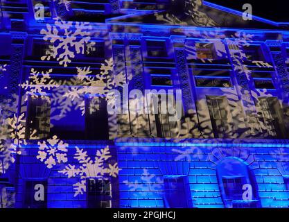 LED snowflake illuminations against a manor house at Christmas Stock Photo