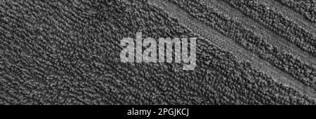 Gray terry towel fabric texture banner. Textile background, top view panoramic web header. Wide screen wallpaper Stock Photo