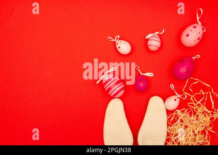 Red backdrop with Easter eggs and bunny ears, plus an area for copying during Easter holidays Stock Photo