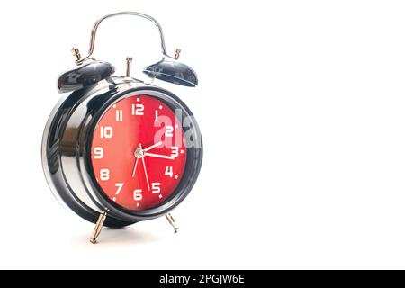 A red and black alarm clock on white background Stock Photo