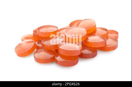 Many orange cough drops on white background Stock Photo