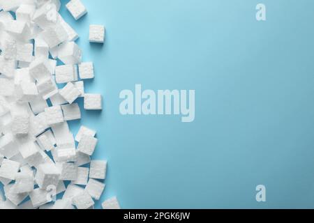 Many styrofoam cubes on light blue background, flat lay. Space for text Stock Photo