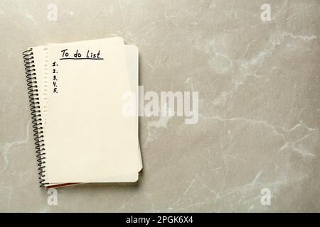 Notepad and torn sheet with unfilled To Do list on light grey marble table, top view. Space for text Stock Photo
