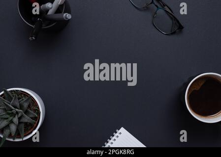 Top view, flat lay business composition with copy space in the middle on black desk. For logo or copy presentation Stock Photo