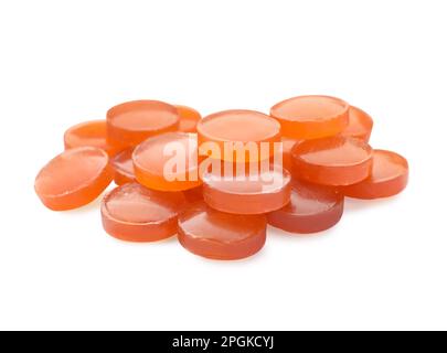 Many orange cough drops on white background Stock Photo