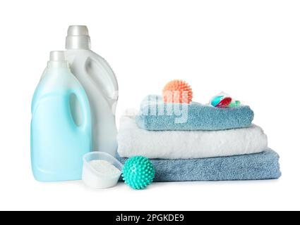 Color dryer balls, detergents and stacked clean towels on white background Stock Photo