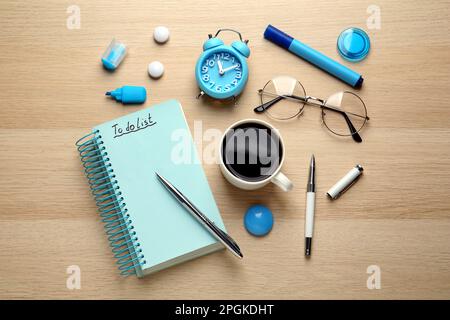 Flat lay composition with unfilled To Do list and cup of coffee on wooden table Stock Photo