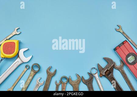 A set of wrenches and working tools on a blue background with a copy space. Labor day. Stock Photo