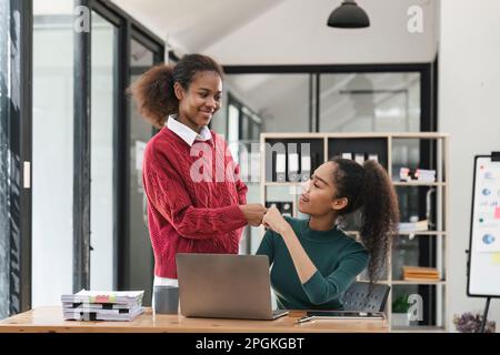 education, school, teamwork and people concept - close up of international students hands making fist bump gesture Stock Photo