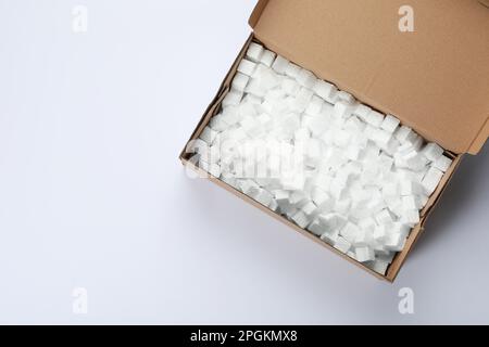 Cardboard box with styrofoam cubes isolated on white, top view Stock Photo
