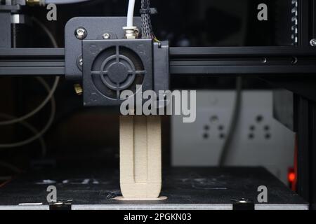 The 3D printing machine makes the 3D prototype model by using wooden PLA filament material Stock Photo