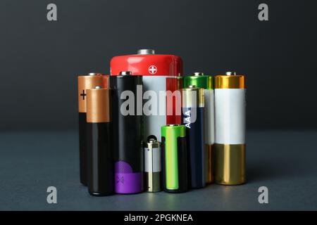 Different types of batteries on dark background Stock Photo