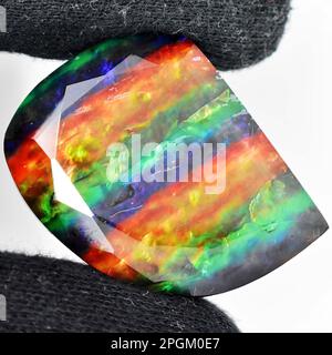 Natural gem iridescent ammolite isolated on white background Stock Photo